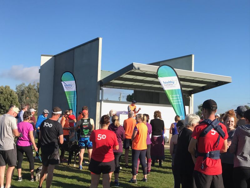 Runners standing outside.  parkrun Inc’s parkrun program is a free, weekly event that encourages physical activity, volunteering and community connectedness.